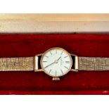 A 9ct yellow gold Omega ladies wristwatch, on 9ct yellow gold bark effect bracelet, 2 x spare links,