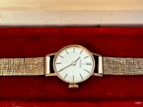 A 9ct yellow gold Omega ladies wristwatch, on 9ct yellow gold bark effect bracelet, 2 x spare links,
