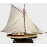 A large model pond yacht on stand, with three masted sails, approx. 93cm long, together with, a