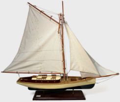 A large model pond yacht on stand, with three masted sails, approx. 93cm long, together with, a