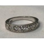 An 18ct white gold half hoop eternity ring, milligrain set with 7 x round brilliant cut diamonds,