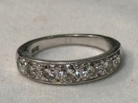 An 18ct white gold half hoop eternity ring, milligrain set with 7 x round brilliant cut diamonds,