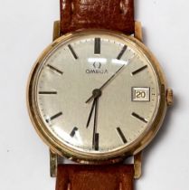 A gents 9ct gold cased Omega wristwatch, the silvered dial with applied gold batons denoting hours
