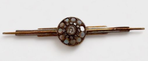 A yellow and white metal bar brooch, tests as 14ct gold, cluster set to the centre with a an old cut