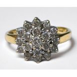 An 18ct yellow gold cluster dress ring, set with 19 x round brilliant cut diamonds, total diamond