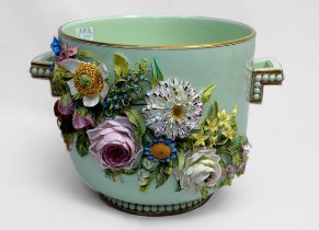 A porcelain twin-handled pail, ornately encrusted with relief moulded flowers to each side, 18.5cm