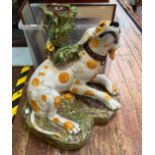 A majolica pottery table base modelled as a Dalmatian dog with yellow spots, raised on