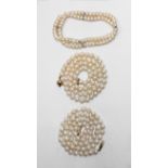 A string of pearls with 18ct gold clasp and another string of pearls with 9ct gold clasp, together