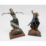 A pair of Art Deco style ceramic figures of flapper dancers, raised on shaped bases, largest