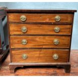 A late Georgian mahogany chest of small proportions, with four graduated drawers and original