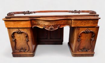 A Victorian mahogny pedestal chiffonier in the rococo style, woth scrolling acanthus carved raised