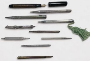 A small collection of writing instruments, including a silver Yard-O-Led propelling pencil, a silver