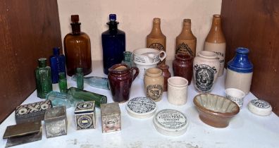 A collection of 19th century poison bottles, glassware, stoneware pottery ginger bottles and printed