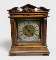 An Edwardian Walnut cased mantel clock of classical temple form, with eight-day movement striking