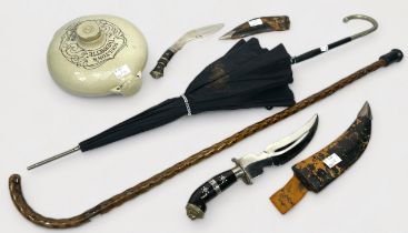 An umbrella and a walking stick, together with two Indian knives in sheathes and a Doulton’s