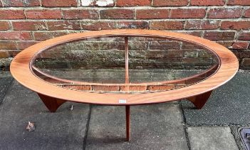 A G-Plan ‘Astro’ coffee table, of oval form, with drop-in glass top to teak base, 122cm long