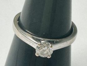 An 18ct white gold solitaire diamond ring, four-claw set with a round brilliant cut diamond,