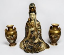 A Japanese Satsuma pottery figure of seated female buddhist deity, dressed in polychrome enamelled