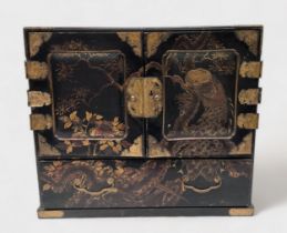 A Japanese lacquer table cabinet, two doors enclosing further drawers and long drawer beneath,