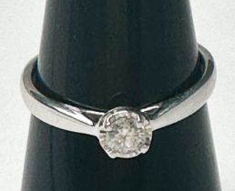 A 9ct white gold solitaire diamond ring, claw set with a round brilliant cut diamond, estimated