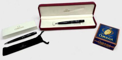 Two Omega watch branded ballpoint pens, boxed, together with a vintage Omega card pocket watch box