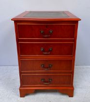 A modern yew wood lockable two drawer filing cabinet, modelled as a chest of four drawers, the top