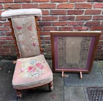 A Victorian walnut Prie Dieu chair, with floral petit-point upholstered seat and back panel, on