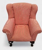 A Child's wingback armchair with red check upholstery, on carbiole supports (a/f)