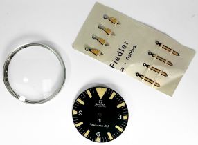 A replacement Omega Seamaster 300 dial, with luminous Tritium markers denoting hours and Arabic