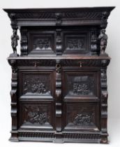 A 19th century Flemish oak court cupboard, the moulded cornice over a carved frieze with lion's mask