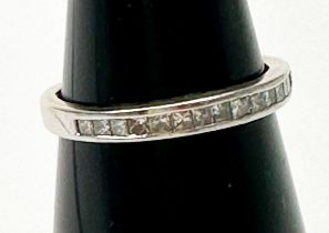 A 14ct white gold half eternity ring, channel set with princess cut diamonds, estimated total