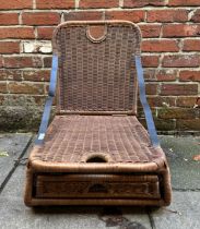 A Rattan wovan folding picnic chair with compartmented base