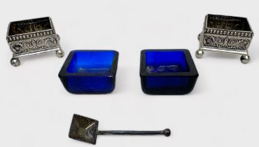 A pair of Victorian silver open table salts, of square form with embossed Arabesque decoration on