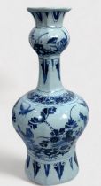 A Dutch Delft pottery vase of hexagonal baluster form, decorated underglaze in cobalt blue with