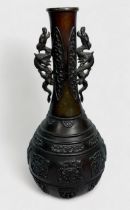 A Chinese cast and patinated bronze vase, late Qing Dynasty, of globular form with elongated neck