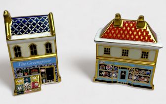 Two Royal Crown Derby porcelain paperweights, 'The China Shop,' and 'The Greengrocer,'