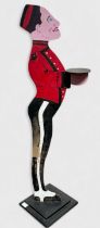 A painted wooden 'Bell Boy' dumb waiter, in profile, on stepped wooden base, 89cm high