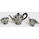 A George V three-piece silver teaset of circular panelled form on circular spreading foot, the