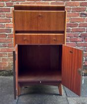 A 1950s walnut metamorphic cocktail cabinet by Nathan Furniture, with fall-front enclosing a