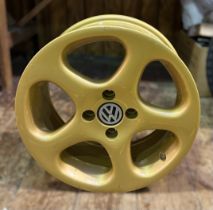 A Volkswagen gold-coloured wheel, produced in 2012 by Pon Holdings (Importer of Volkswagen to the