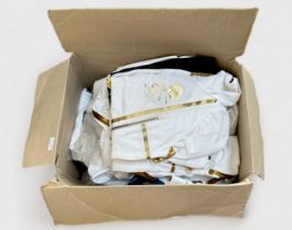A collection of assorted London 2012 Olympic official torch bearer outfits, in white with gold