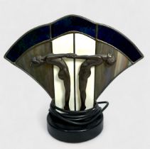 An Art Deco style table lamp, cast with a pair of nude dancing girls in profile before a fan