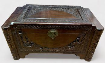 A Chinese camphor wood-lined blanket box, carved with figures and foliage, with brass lock, 91cm