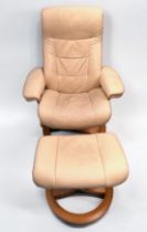 A cream leather reclining swivel armchair and matching footstool