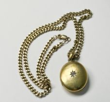 A 9ct yellow gold oval-shaped locket measuring approximately 36mm x 28mm, star set to the centre