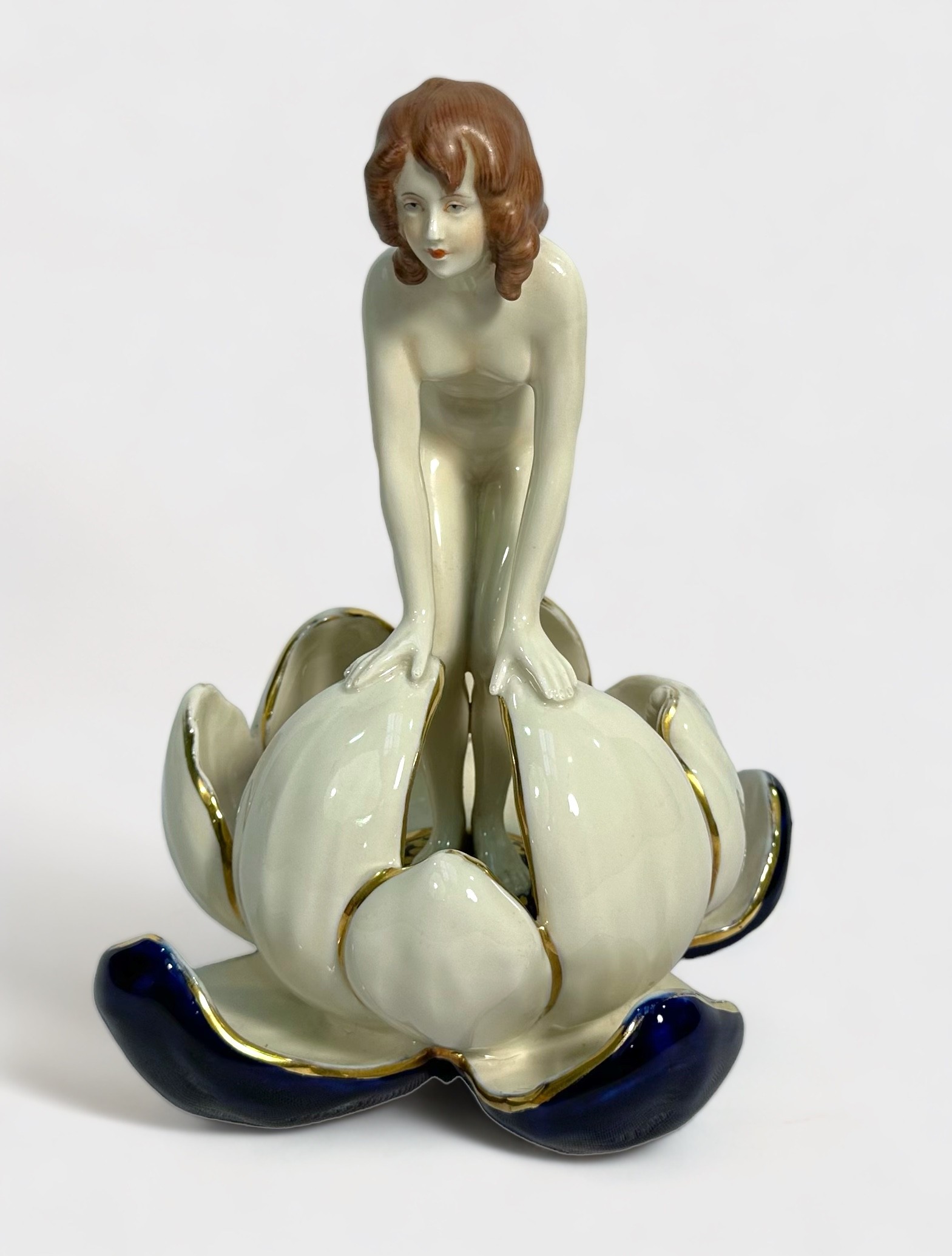 A Royal Dux porcelain figure of a nymph emerging from a waterlily, applied triangle mark to base and