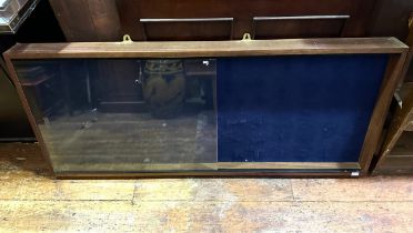 A wall-mounted mahogany and felt-lined display case, with two clear-glass sliding doors, 142cm long