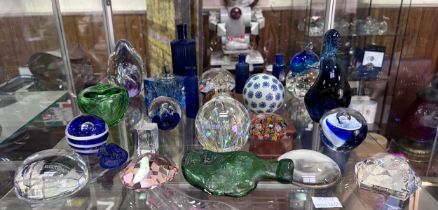 A collection of various glass paperweights, poison bottles etc