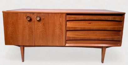 A 1960s Lebus teak laminate sideboard, with three long dovetailed drawers to one half and pair of