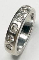 An 18ct white gold diamond ring, flush-set with seven round diamonds, estimated total diamond weight